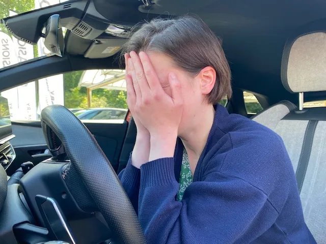 Femme paniquée devant un problème avec ses voyants voiture allumés