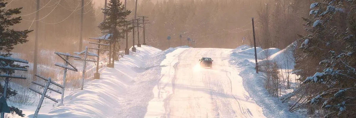 Voiture sur une route enneigée